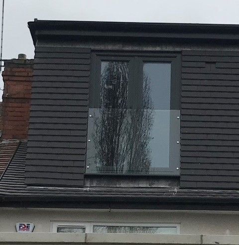 Anthracite grey UPVC French doors with glass balustrade.: Swipe To View More Images