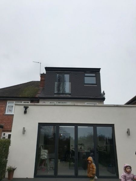 Flat roof dormer with smooth grey plain concrete hanging tiles.: Swipe To View More Images