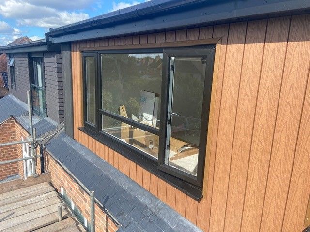 Flat roof dormer, vertical composite cedar cladding.: Swipe To View More Images