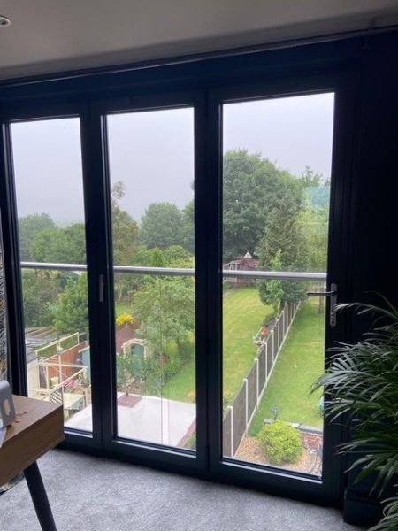 Loft conversion with aluminium bi-folding doors.: Swipe To View More Images