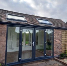Garage conversion with vaulted feature velux windows & grey Aluminium bi-folding doors.: Click Here To View Larger Image